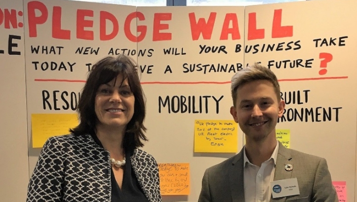 Energy Minister Claire Perry and edie's content director Luke Nicholls stood in front of a real-life version of the Mission Possible Pledge Wall at the Sustainability Leaders Forum in London